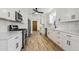 Kitchen with white cabinets, stainless steel appliances, and modern fixtures at 1522 Utah St, Golden, CO 80401