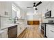 Kitchen with white cabinets, stainless steel appliances, and modern fixtures at 1522 Utah St, Golden, CO 80401