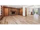 Bright living room with a brick fireplace, wooden floors, and modern railing at 1522 Utah St, Golden, CO 80401