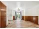 Bright living area featuring wood floors, classic wall paneling and door to the back yard at 1522 Utah St, Golden, CO 80401