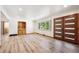 Open living area with built-in shelves, hardwood floors, and a large window at 1522 Utah St, Golden, CO 80401