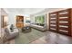 Bright living room with hardwood floors, large windows, and modern furniture and built in shelving at 1522 Utah St, Golden, CO 80401