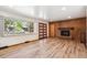 Open living room featuring a cozy fireplace and hardwood floors at 1522 Utah St, Golden, CO 80401