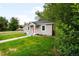 Charming home with gray siding, a red front door, and a well-manicured lawn at 4406 S Delaware St, Englewood, CO 80110
