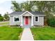 Charming home with gray siding, a red front door, and a well-manicured lawn at 4406 S Delaware St, Englewood, CO 80110