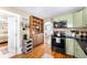Charming kitchen features sage green cabinets and hardwood floors at 4406 S Delaware St, Englewood, CO 80110