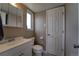 This bathroom includes a modern sink, toilet, and mirror, with a utility door at 701 Tucson, Aurora, CO 80011