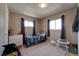 Cozy bedroom featuring natural light, neutral walls, and a comfortable sleeping area at 701 Tucson, Aurora, CO 80011