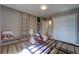 Bedroom with hardwood floors, built in bookcase and storage, and closet with sliding doors at 701 Tucson, Aurora, CO 80011