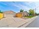 View of the detached garage and fenced yard with mature trees at 701 Tucson, Aurora, CO 80011
