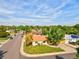 Cozy tan home with a manicured lawn, a street corner view, and mature trees surrounding the property at 701 Tucson, Aurora, CO 80011
