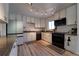 Well-lit kitchen featuring stylish track lighting, white cabinets and modern appliances at 701 Tucson, Aurora, CO 80011