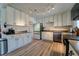 A modern kitchen with white cabinets, granite counters, stainless steel appliances, and modern flooring at 701 Tucson, Aurora, CO 80011