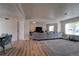 Spacious living room features light colored, wide-plank floors and a gray sectional sofa at 701 Tucson, Aurora, CO 80011