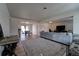 Spacious living room with a large sectional couch, modern flooring, and an open layout at 701 Tucson, Aurora, CO 80011
