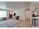 Bright living room with modern flooring, an exterior door, and an open layout at 701 Tucson, Aurora, CO 80011