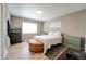 This main bedroom includes hardwood floors and two windows for plenty of natural light at 701 Tucson, Aurora, CO 80011