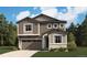 Charming two-story home with a two-car garage and a beautifully landscaped front yard at 445 S Salida St, Aurora, CO 80017