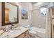 Bathroom with a large mirror, single vanity, bathtub with shower, and a window offering natural light at 31058 Big Bear Dr, Evergreen, CO 80439