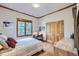 Charming bedroom featuring wood floors, classic wood trim, and ample natural light from the large window at 31058 Big Bear Dr, Evergreen, CO 80439