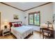 Comfortable bedroom featuring wood floors, a side table with a lamp, and a quaint writing desk at 31058 Big Bear Dr, Evergreen, CO 80439
