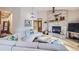 Living room featuring a stone fireplace, hardwood floors, and a large white sofa at 31058 Big Bear Dr, Evergreen, CO 80439