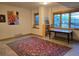 Living room with decorative rug, natural light from windows, and warm ambiance for entertaining or relaxation at 31058 Big Bear Dr, Evergreen, CO 80439