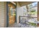 Private porch with seating, an ornate door, and views of the lawn at 31058 Big Bear Dr, Evergreen, CO 80439