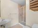 Bathroom with pedestal sink, tile floors, and glass shower enclosure at 925 N Lincoln St # 12G, Denver, CO 80203