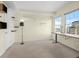 Bright bedroom with large windows, soft carpet, a unique shelving system, and a modern desk at 925 N Lincoln St # 12G, Denver, CO 80203