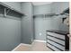 Walk-in closet with shelving units and stylish dark dresser with glass drawers at 925 N Lincoln St # 12G, Denver, CO 80203