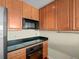 Efficient kitchen featuring wooden cabinetry, granite countertops, and stainless steel appliances at 925 N Lincoln St # 12G, Denver, CO 80203