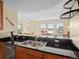 Kitchen featuring dark countertops, stainless steel appliances, and open view into the living area at 925 N Lincoln St # 12G, Denver, CO 80203