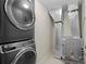 Laundry area with stacked washer and dryer, next to the furnace at 925 N Lincoln St # 12G, Denver, CO 80203