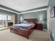 Spacious bedroom with tray ceiling and private balcony access at 925 N Lincoln St # 12G, Denver, CO 80203