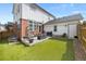 Low maintenance backyard with artificial turf, patio and modern outdoor furniture at 5404 W 95Th Pl, Westminster, CO 80020