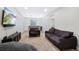 Basement featuring two sofas and a bar area with a mini fridge at 5404 W 95Th Pl, Westminster, CO 80020