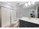 Modern bathroom features a glass-enclosed shower with white subway tile and gray vanity with a sink at 5404 W 95Th Pl, Westminster, CO 80020