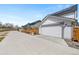 Exterior facade featuring driveway with two-car garage and visible solar panels at 5404 W 95Th Pl, Westminster, CO 80020
