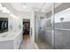 Main bathroom featuring dual sinks, a walk-in shower, and a closet at 5404 W 95Th Pl, Westminster, CO 80020