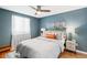 Comfortable bedroom with a ceiling fan, bright window, and stylish modern decor at 148 S Emerson St # 206, Denver, CO 80209