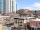Urban scenery with a mix of low-rise apartments and soaring high-rise buildings under a clear, blue sky at 148 S Emerson St # 206, Denver, CO 80209