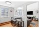 Bright dining area with seating for three and view into living space through pass-through window at 148 S Emerson St # 206, Denver, CO 80209