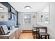 Bright dining area with seating for three and view into living space through pass-through window at 148 S Emerson St # 206, Denver, CO 80209