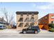 Well-maintained apartment building with vintage awnings, street parking, and mature trees at 148 S Emerson St # 206, Denver, CO 80209