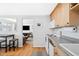 Updated kitchen with white appliances, grey counters, and an open view to the living area at 148 S Emerson St # 206, Denver, CO 80209