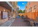 Outdoor patio area with tables, chairs, grill, and stairs leading to the upper floors at 148 S Emerson St # 206, Denver, CO 80209
