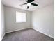 Cozy bedroom featuring neutral walls, carpet, ceiling fan, and a window with natural light at 3419 W Walsh Pl, Denver, CO 80219