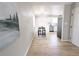 Cozy dining room featuring hard wood floors, new lighting, and bright walls with sight lines to the kitchen at 3419 W Walsh Pl, Denver, CO 80219