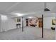 Spacious finished basement with neutral carpet, decorative tile accent wall, and support columns at 435 Cody Dr, Lakewood, CO 80226